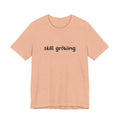 Beige t-shirt with 'still growing' text on a white background
