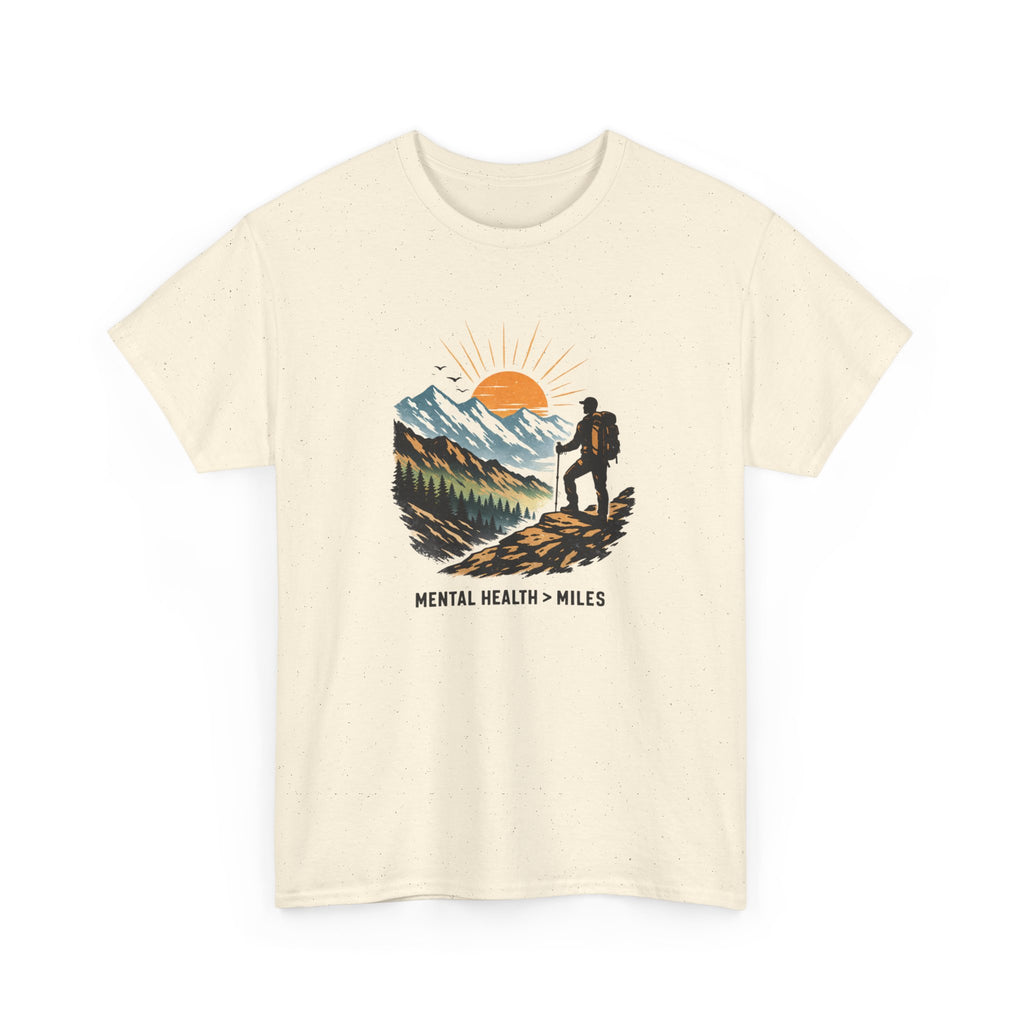 Beige t-shirt with a mountain and person graphic and 'Mental Health > Miles' text on a white background