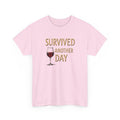 Pink t-shirt with a graphic of a wine glass and text 'SURVIVED ANOTHER DAY' on a white background