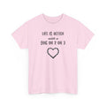 Pink t-shirt with text 'Life is better with a dog or 2 or 3' and a heart design on a white background