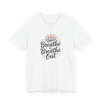 White t-shirt with 'Breathe in Breathe Out' text and lotus flower design on a white background
